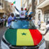 Anhängare till Bassirou Diomaye Faye firar segern på bilden en bil meed flagga och jublande människor.